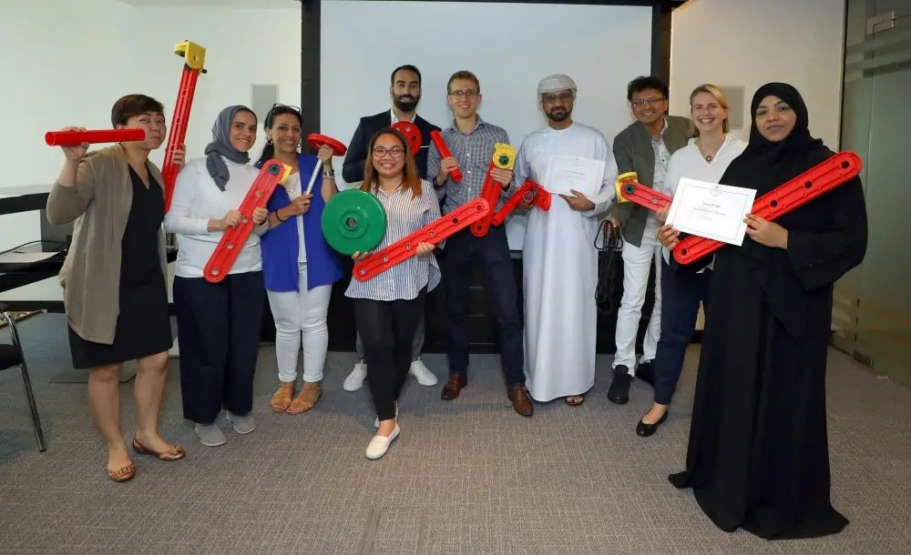 Participants engaged in a team-building activity, enhancing communication, trust, and collaboration.