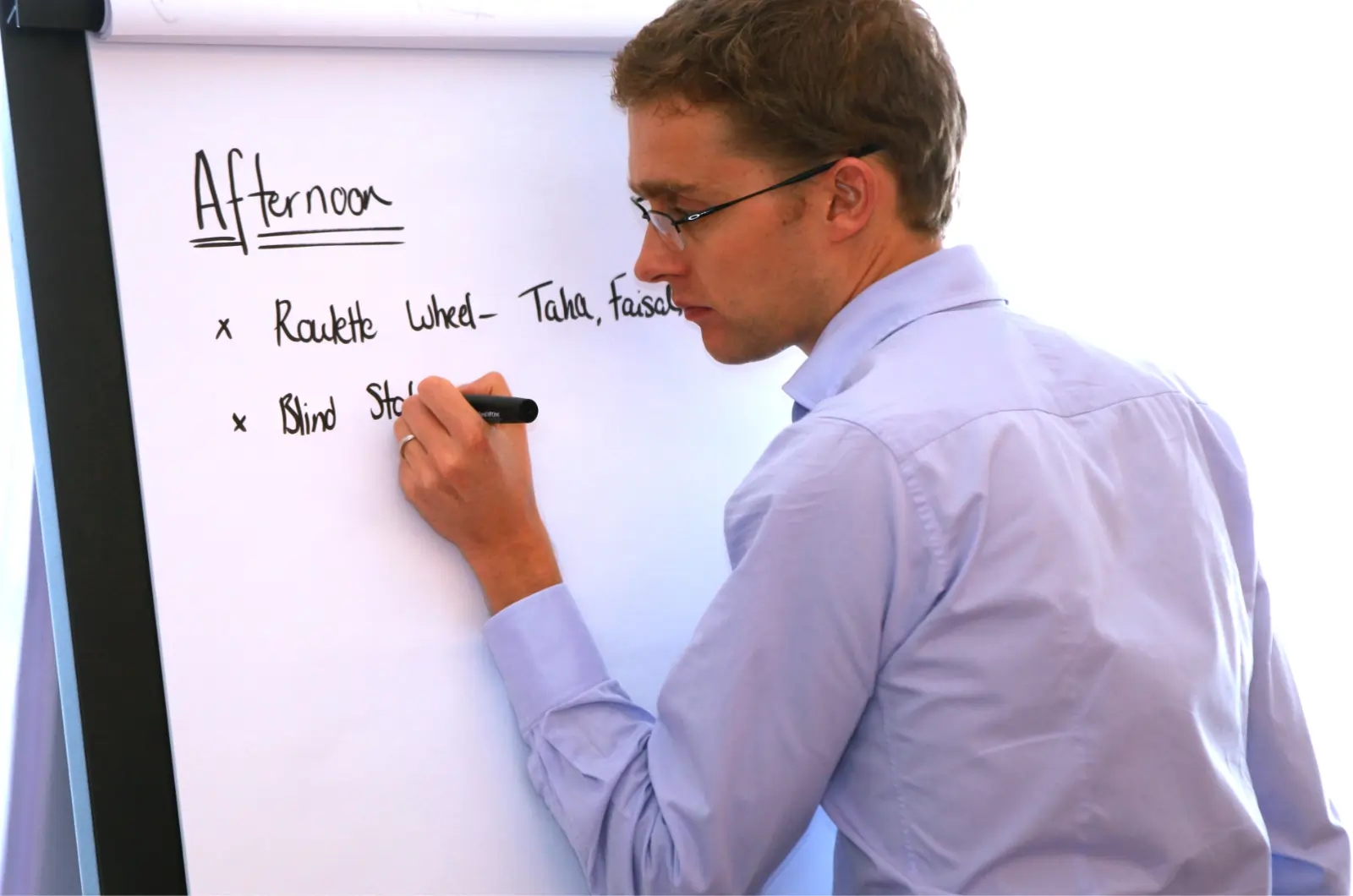 The MD of MTa Learning, Jamie, introducing a session's schedule on a whiteboard