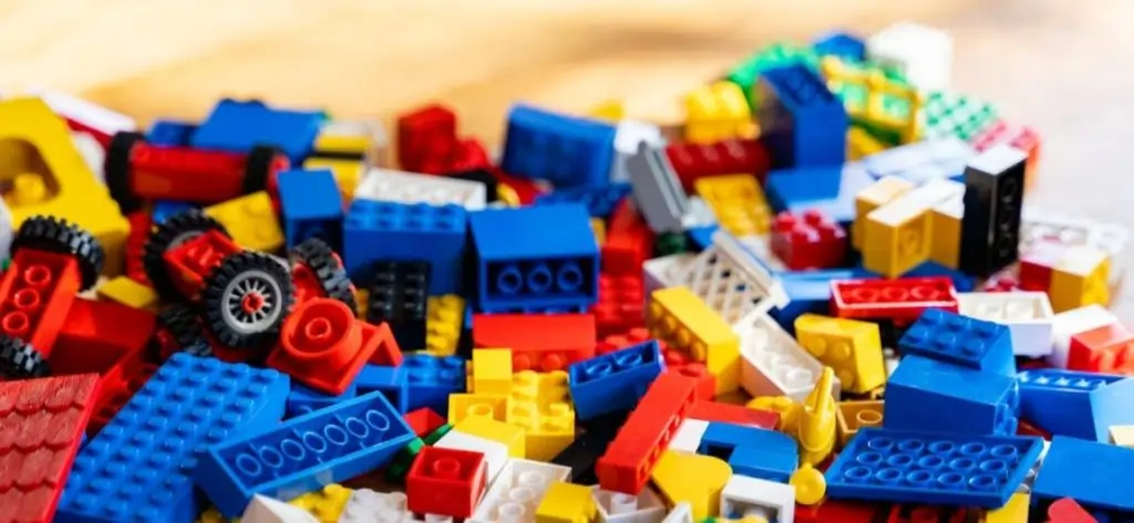 A pile of Lego bricks, used in team-building activities to develop communication, creativity, and problem-solving skills.