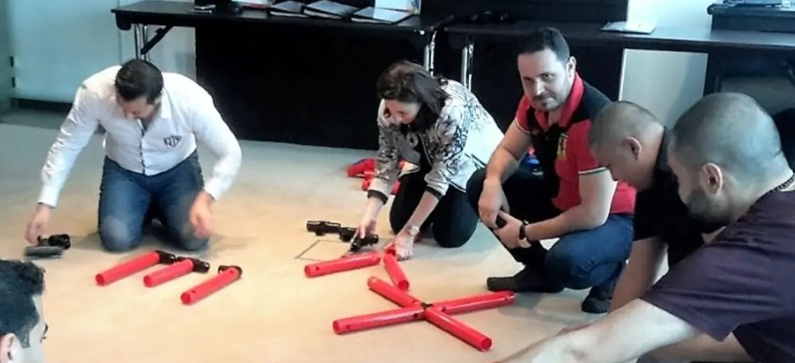 A group of people engaged in the MTa Digital Display activity, collaborating to improve team performance.