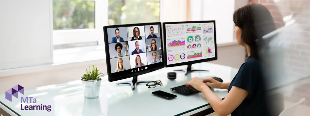 Lady engaging in business simulation games on dual screens, enhancing strategic thinking and teamwork skills.