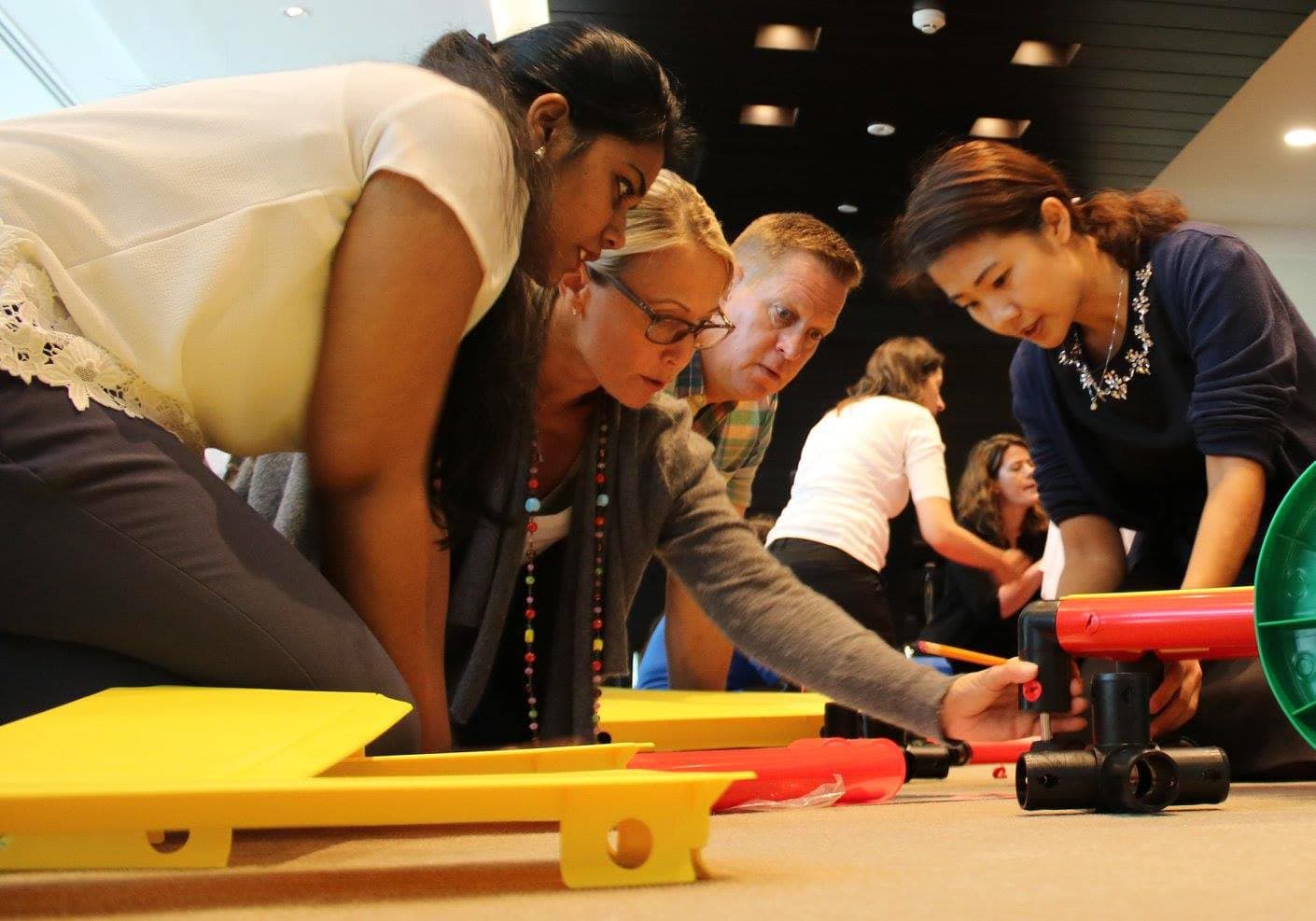 Participants actively using the MTa Team Kit to enhance teamwork and explore team dynamics.