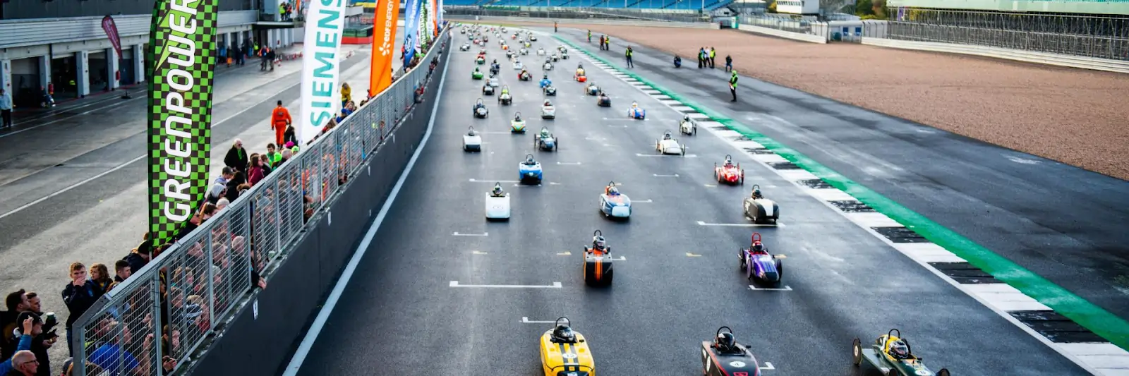 Students building and racing a soapbox car as part of the Greenpower challenge, applying STEM skills in design, engineering, and racing.