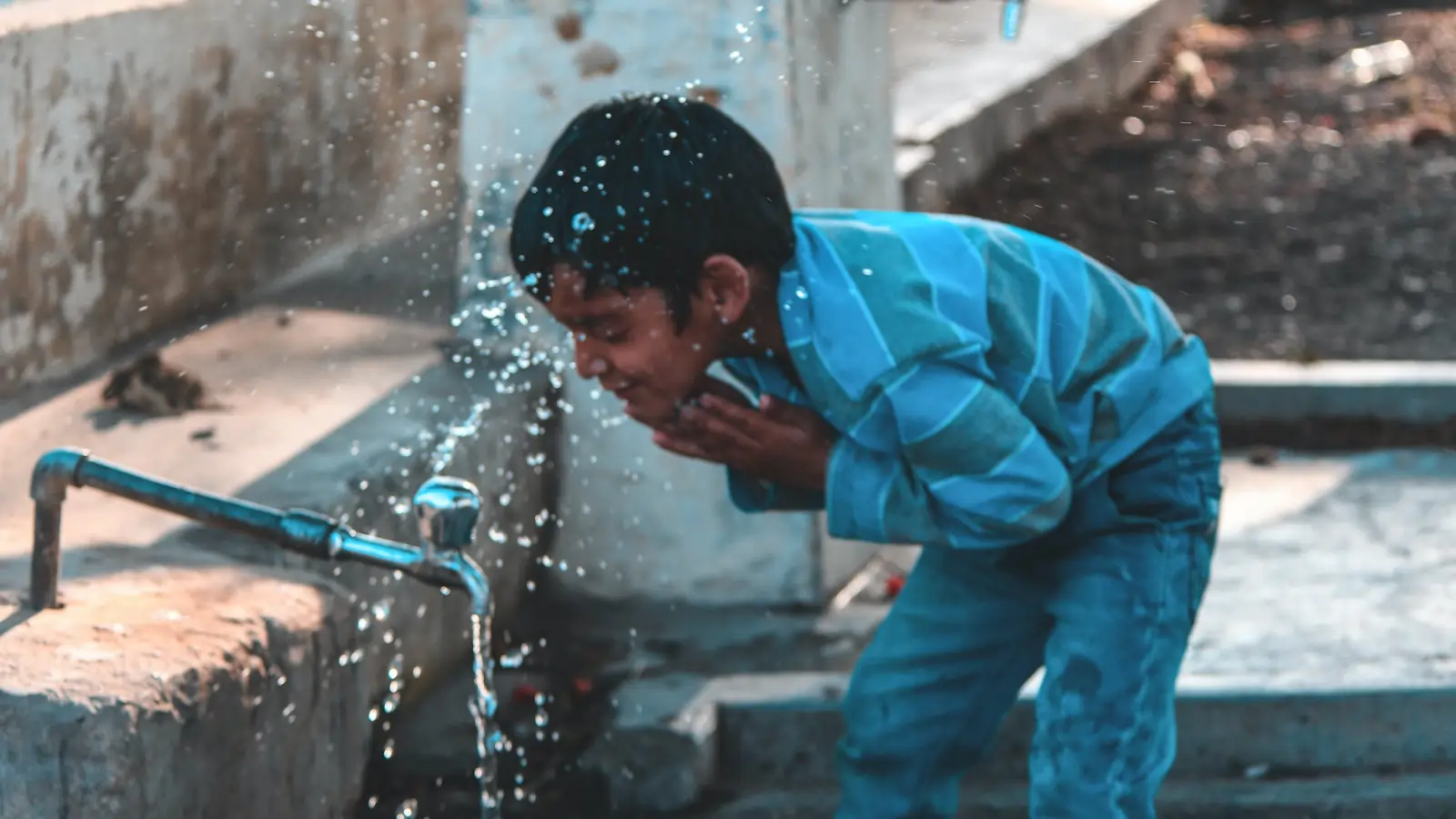 A child interacting with a waterpipe, actively engaged in a STEM activity to design a game that promotes water conservation in the home, focusing on smart shower usage and efficiency.