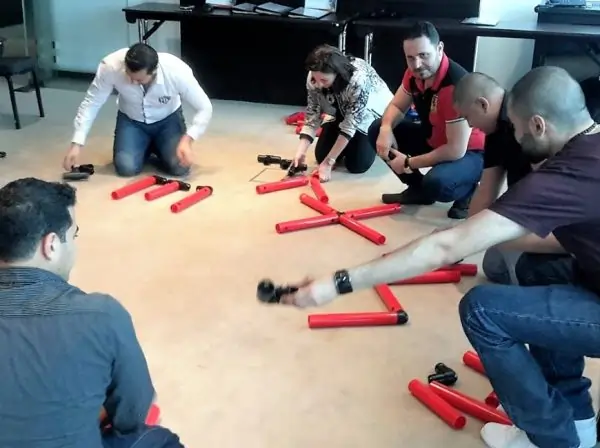 Participants discussing MTa Team kit at a masterclass, exploring team development through activities