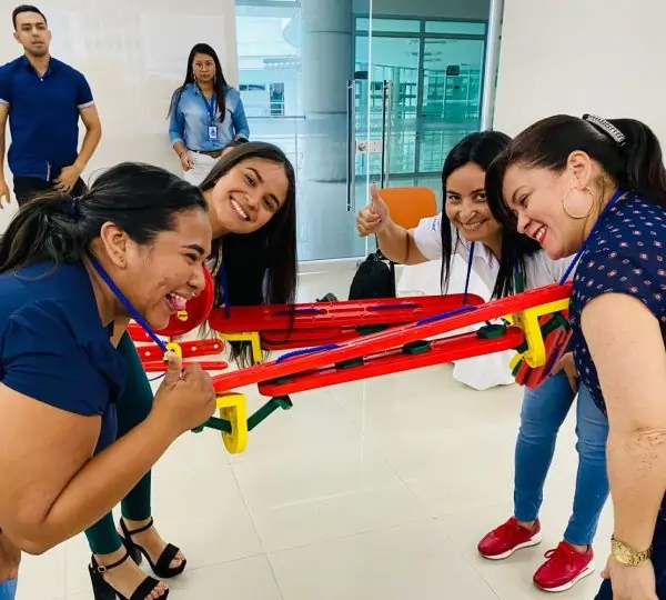 Group of participants engaging in an MTa Masterclass, learning teamwork and survival skills through experiential activities