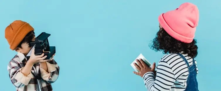 Children filming a stop motion animation, actively planning and capturing still images to create a short film.