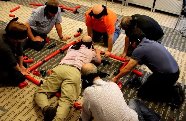 Blindfolded participants use MTa Team kit to enhance coaching and facilitation skills in Germany.