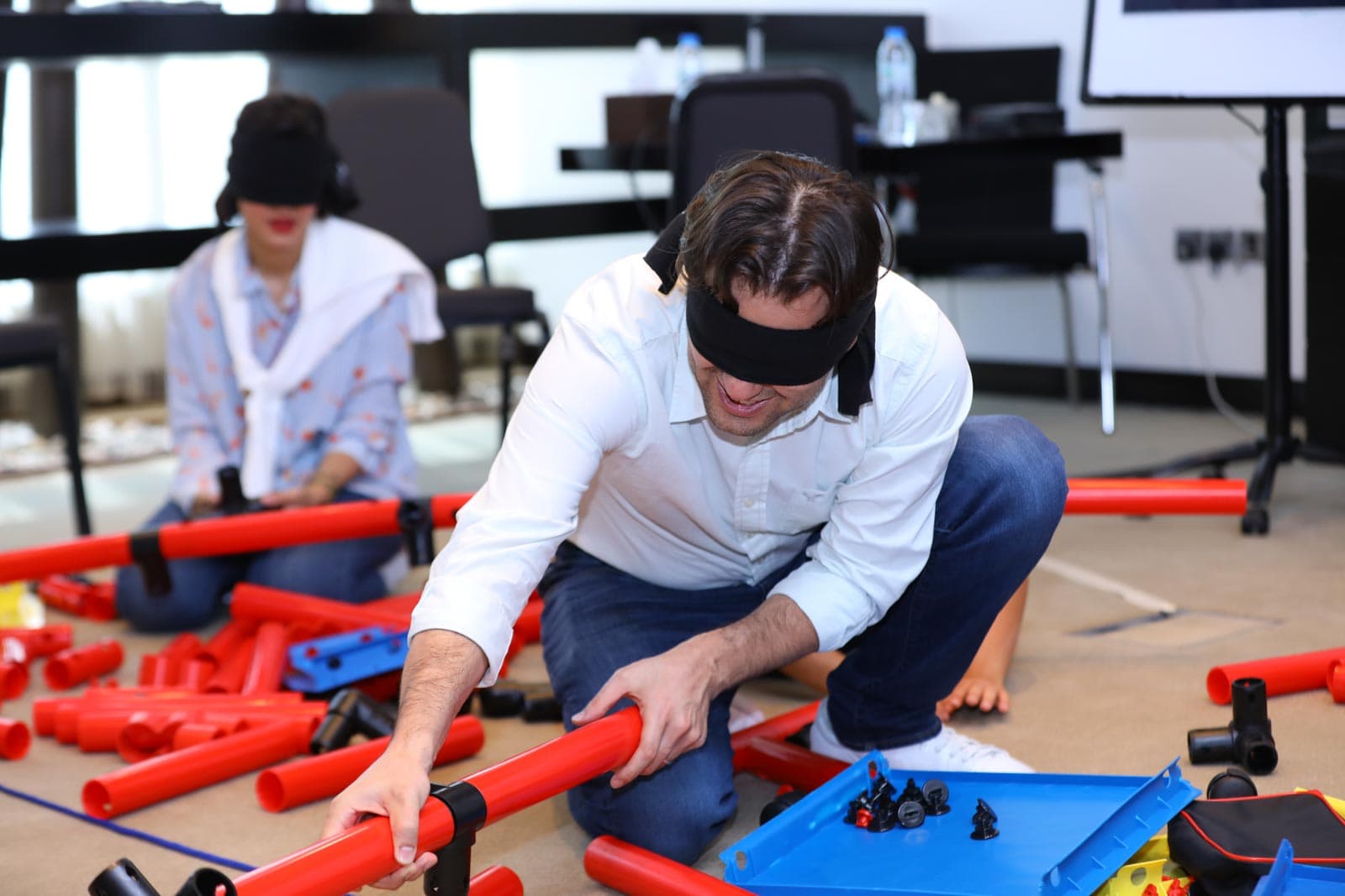 Blindfolded employee engaged in a training activity using an MTa Learning kit