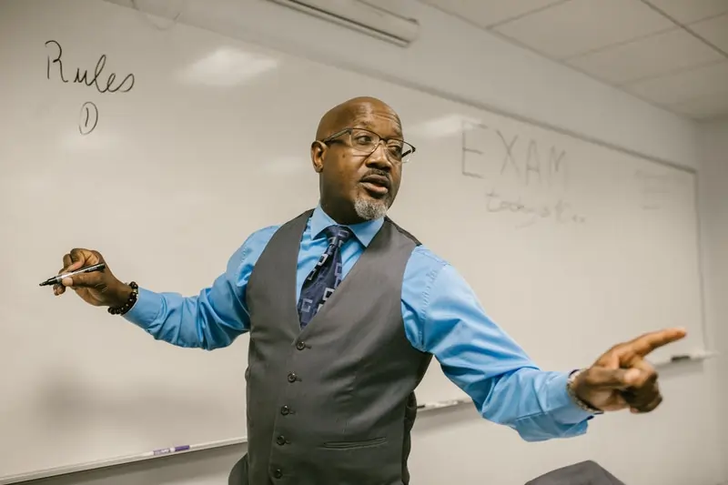 A facilitator writing on a whiteboard during an Office Quiz, encouraging team bonding, collaboration, and problem-solving in a team-building session.